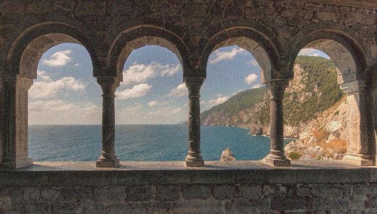 Stone cloister archways overlooking the Mediterranean sea